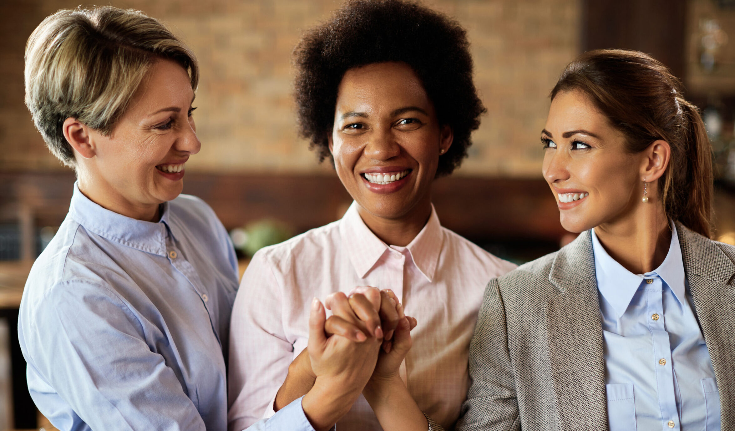 happy businesswomen supporting each other